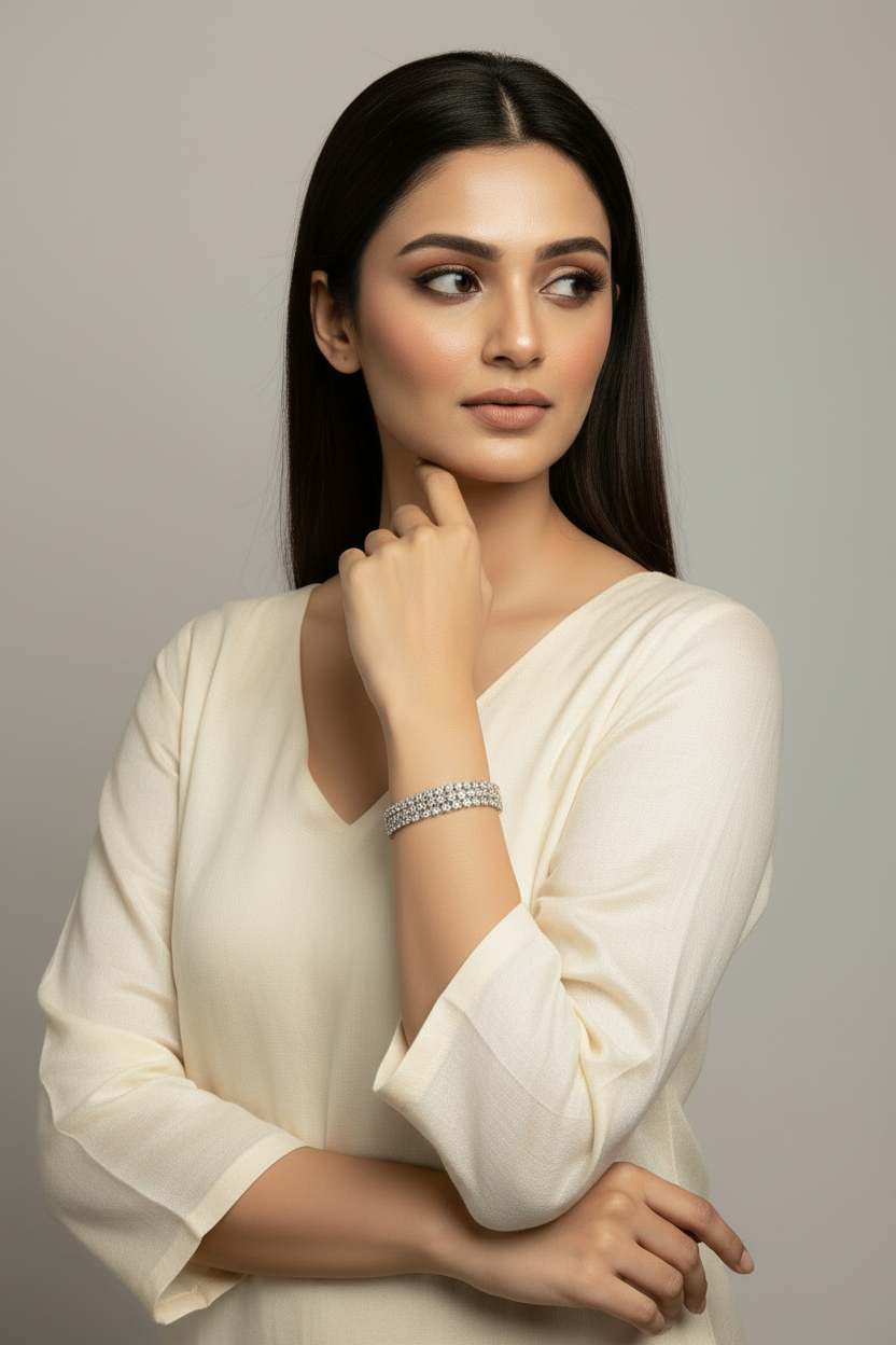 South Asian model with straight hair wearing double-row crystal tennis bracelet with ivory kurta